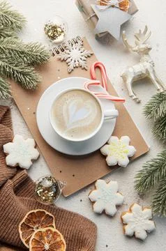 A cup of coffee latte, homemade cookies and Christmas balls and knitted sweat Stock Photos
