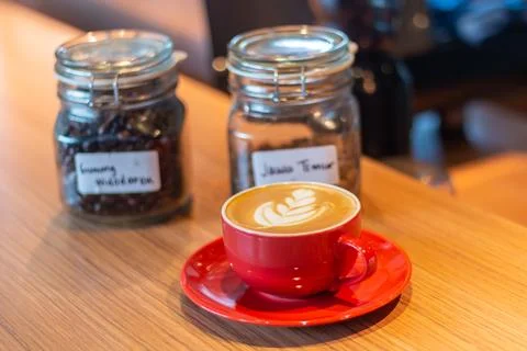 Cup of coffee latte on table with selective focus Stock Photos