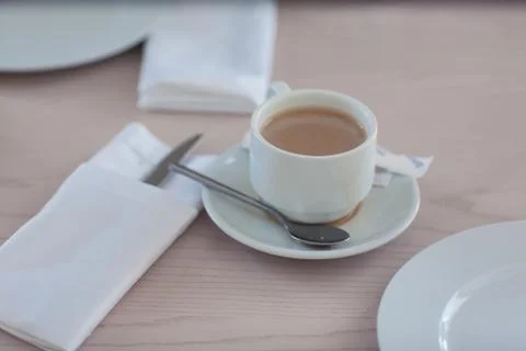 A cup of coffee on a light table Stock Photos