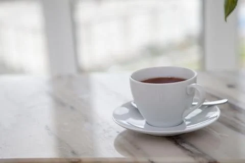 Cup of coffee on marble table Stock Photos