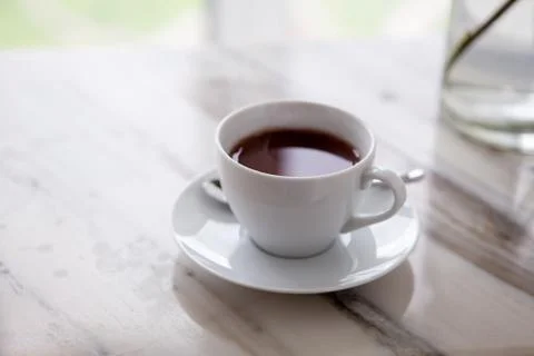 Cup of coffee on marble table Stock Photos