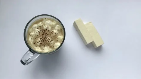 Cup of coffee with marshmallows and cinnamon. Breaks the pastille Stock Footage 132393544