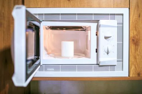 Cup of coffee in a microwave Stock Photos