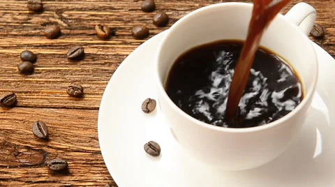 A cup of coffee milk and coffee beans. Stock Footage 57703359