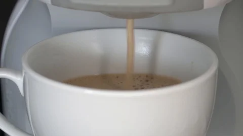 Cup of coffee with milk being poured with capsule coffee machine Stock Footage 88032206