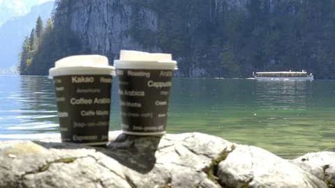Cup of coffee in the morning next to the lake in mountains. Stock Footage 75164053