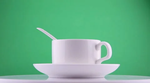 Cup of coffee moves on a green background Stock Footage 62134018