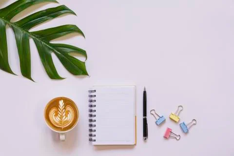 A cup of coffee with note and copy space on white background. Office desk and Stock Photos