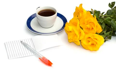 Cup of coffee, notebook with the handle and a bouquet of yellow roses, the fr Stock Photos