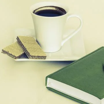 Cup of coffee with notebook Stock Photos