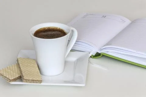 Cup of coffee with notebook Stock Photos
