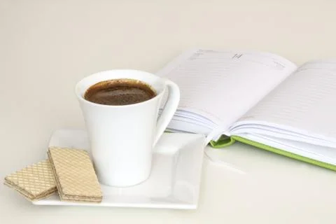 Cup of coffee with notebook Stock Photos