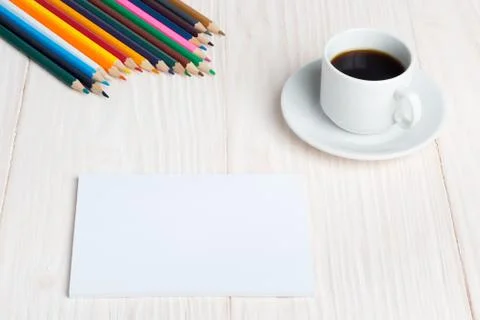 Cup of coffee Notepad pencils on the table Stock Photos