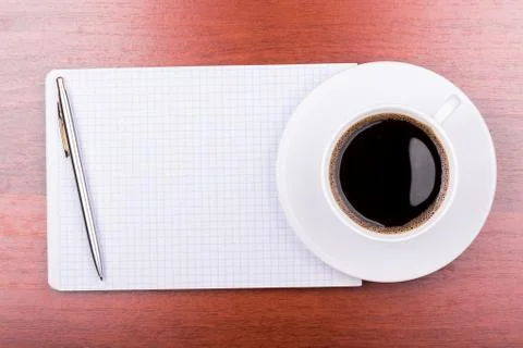 Cup of coffee on notepad Stock Photos