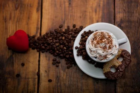 Cup of coffee  on the old background with coffee beans Stock Photos