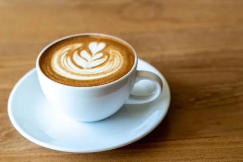 A cup of coffee on old wooden table in cafe coffee break in morning Stock Photos