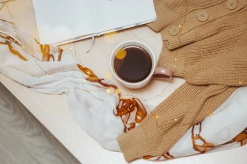 A Cup of coffee, an open diary on empty pages lie on the table, on which lies Stock Photos