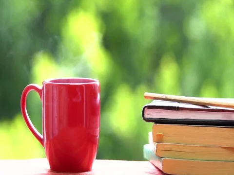 Cup of coffee or tea hot drink on window sill and reading books Video stock 76091917