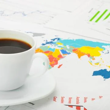  Cup of coffee over world map and financial documents Cup of coffee over w... Stockfoto's