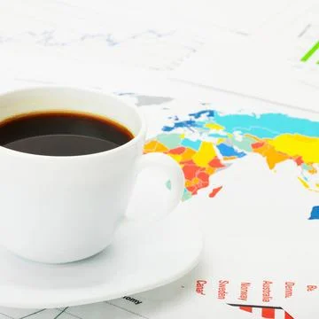 Cup of coffee over world map and financial documents Cup of coffee over wo... Foto stock