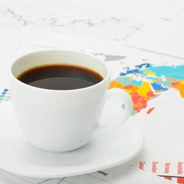 Cup of coffee over world map and financial documents Cup of coffee over wo... 写真素材