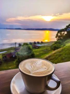 A cup of coffee overlooking the ocean. Stock Photos