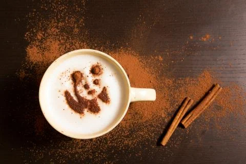 Cup of coffee with panda pattern of cinnamon Stock Photos