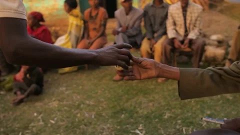 The cup of coffee is passed from hand to hand in sharing, in Ethiopia Stock Footage 206053006
