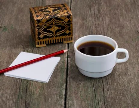 Cup of coffee, pencil with paper and a casket, a still life, a subject drinks Stock Photos