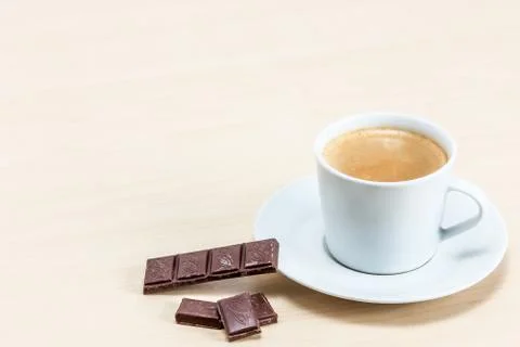 Cup of coffee with piece of chocolate Stock Photos