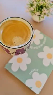 Cup of coffee with planner in the background Stock Photos