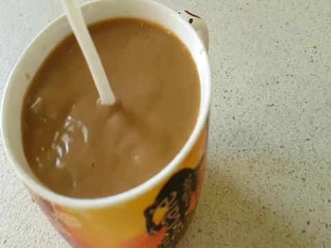 Cup of coffee is pouring milk Stock Footage 80416952