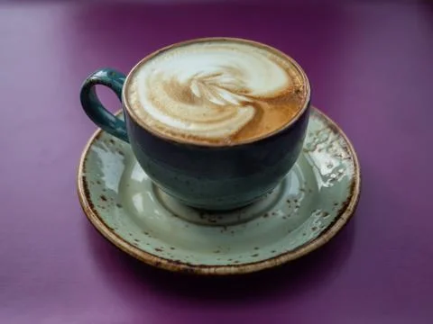 A cup of coffee on a purple table Stock Photos