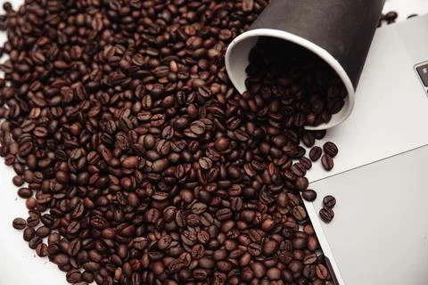 A cup of coffee put on table on laptop and coffee beans Stock Photos