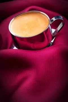 Cup of Coffee with red silk Stock Photos