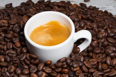 Cup of coffee on roasted beans Stock Photos