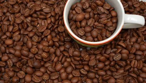 A cup of coffee with roasted beans. Top view with place for text. Stock Photos