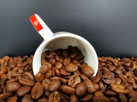 Cup of coffee with roasted dark brown coffee beans Stock Photos