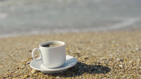 A cup of coffee on the sandy shore Видео 172035670