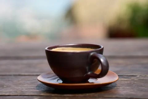A cup of coffee served on a table at a tropical hilltop cafe in Koh Samui, The Stock Photos