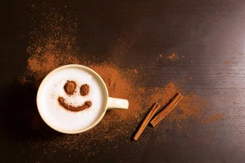 Cup of coffee with smile pattern of cinnamon Stock Photos