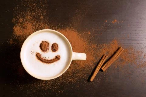 Cup of coffee with smile pattern of cinnamon Stock Photos