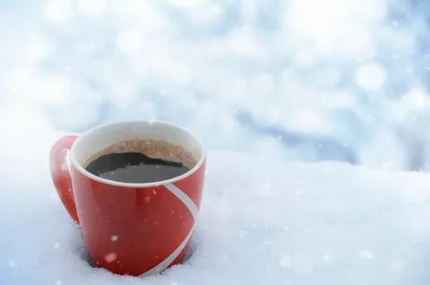 Cup of coffee in snow while snowing Stock Photos
