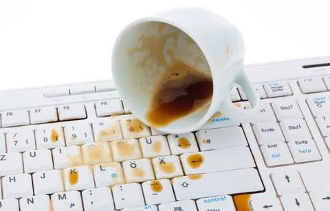  Cup of coffee spilled on keyboard. Kaffeetasse ausgeschüttet auf Tastatur.. Stock Photos
