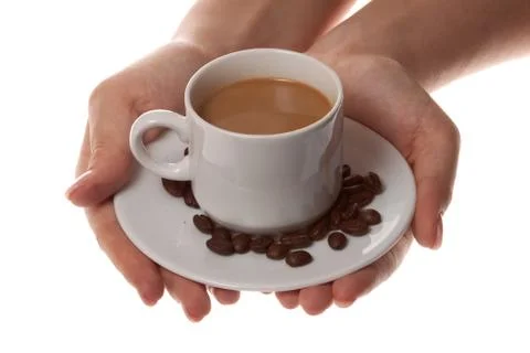 Cup of coffee with spoon and hand on white background Stock-Fotos