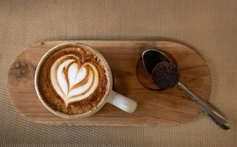 Cup of coffee, spoon and a small cake Stock Photos