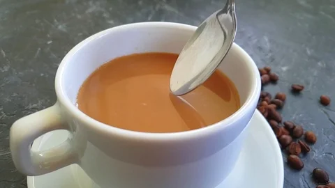 Cup of coffee spoon on concrete background, slow motion Stock Footage 117412203