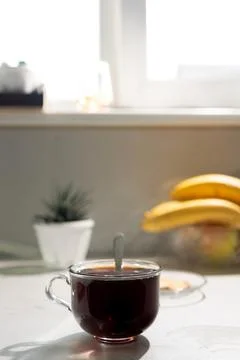 Cup of Coffee With Spoon on Kitchen Counter in Bright Morning Light Stock Photos