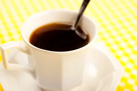 Cup of coffee with spoon Stock Photos