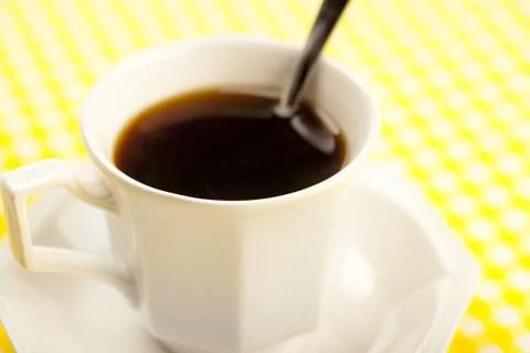 Cup of coffee with spoon Stock Photos